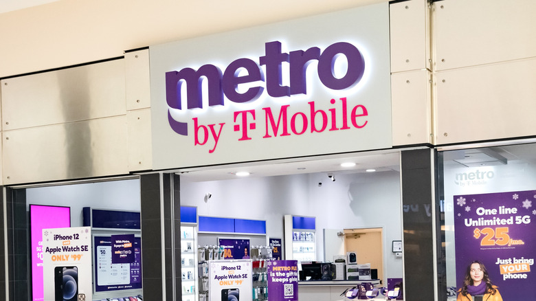 A Metro by T-Mobile storefront with promotional phone plan signs in the window.