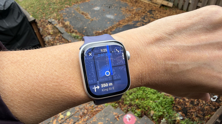 An Apple Watch displaying turn-by-turn walking directions on Apple Maps.