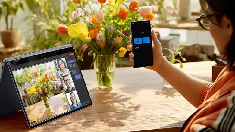 Samsung 16-inch Galaxy Book4 Pro 360 paired with a Galaxy phone illustrating multi-device synchronization.