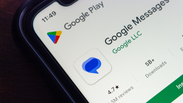 A hand holding a Samsung device showing the Google Messages app listing within the Google Play Store interface.