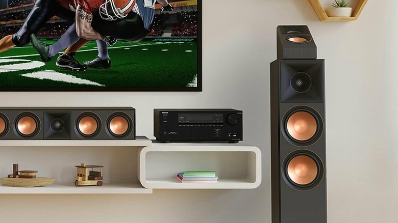The Onkyo TX-NR6100 AV receiver placed on a wooden console in a living room.