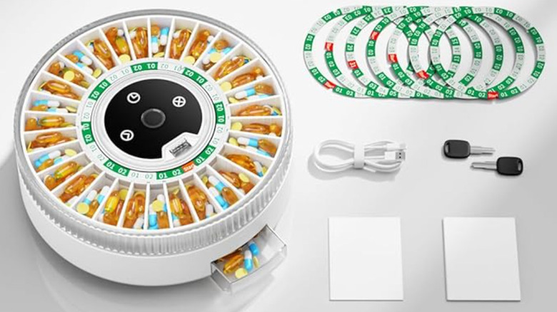 An automated medication dispenser device on a table.