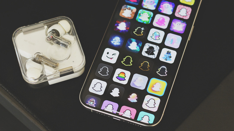 Smartphone screen showing various app icons including the Snapchat ghost logo.