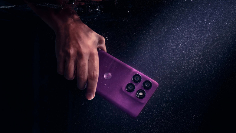 A Motorola Edge 60 Pro being held and used underwater.