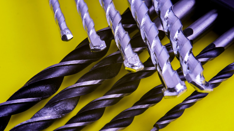 Close-up of several masonry drill bits with carbide tips.