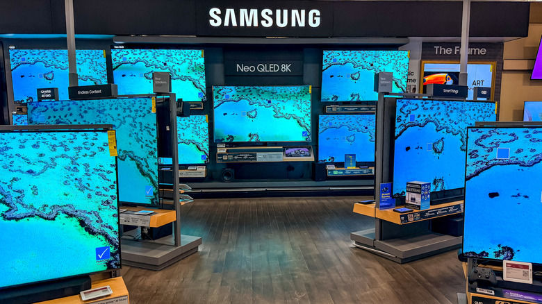 A showroom floor filled with various Samsung 4K smart televisions on display.