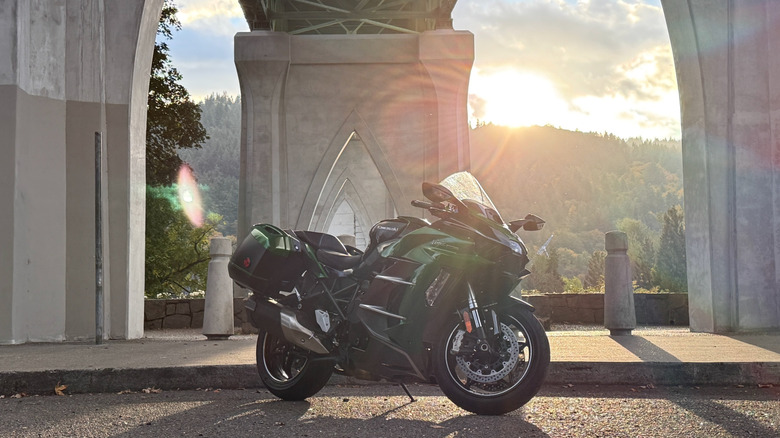 Kawasaki Ninja H2 SX parked under a large bridge structure in Portland, Oregon.