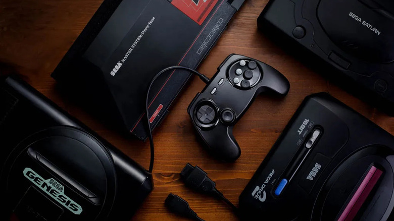 A black Fighters BrawlerGen controller connected to a Sega Genesis console.