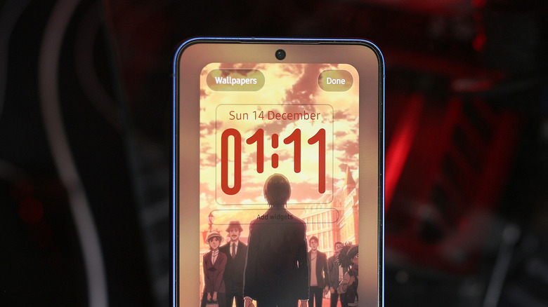 A Samsung Galaxy device featuring a landscape wallpaper with a prominent subject interacting with the Adaptive Clock digits.