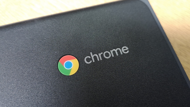 A close-up shot of the Google Chromebook logo on the corner of a black device.
