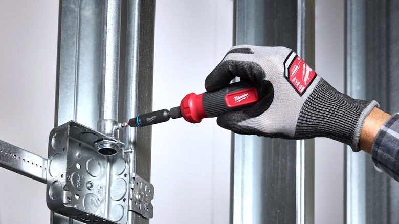 A person using the Milwaukee Shockwave screwdriver to drive a fastener.