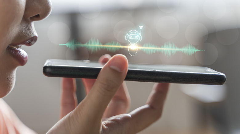 A woman interacting with her smartphone using voice commands.