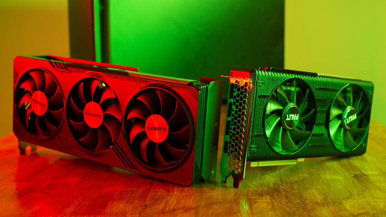 Two high-performance modern graphics cards side by side with vibrant RGB lighting.