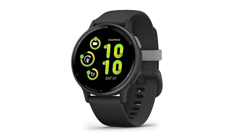 A black Garmin smartwatch with a round watch face displaying the time in green.