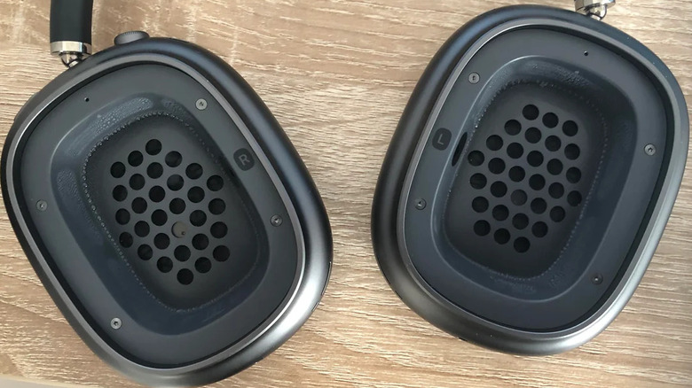 A close-up view of water droplets and condensation buildup inside the ear cup of a silver AirPods Max.