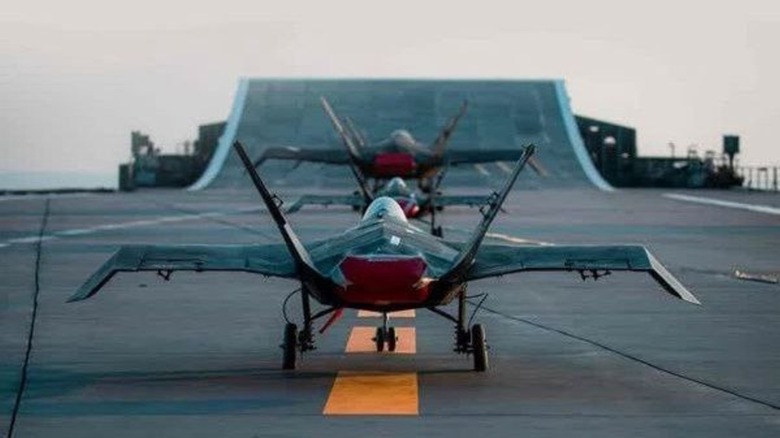 Jask-313 drones aligned on the ski-jump flight deck of the Shahid Bagheri preparing for takeoff.