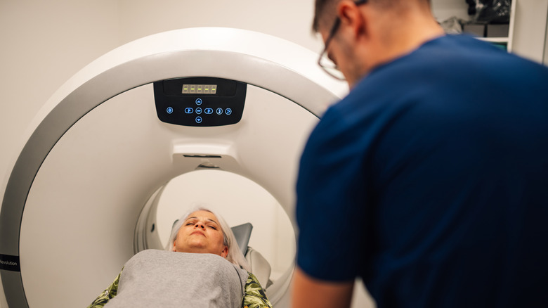A patient entering a modern CT scanner for a routine medical examination.