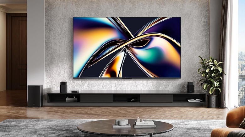 A Hisense 75-inch Mini-LED ULED TV mounted on a wall showing vivid cinematic content.
