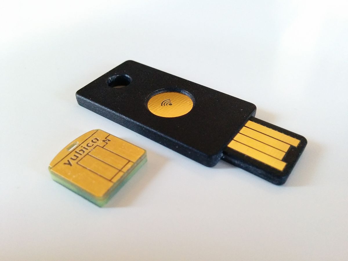A person using a security key via NFC on a smartphone for secure login.