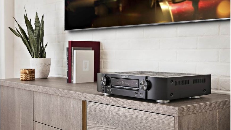 A slim Marantz NR1510 receiver sitting on an entertainment center.