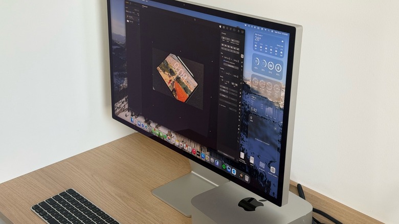 An Apple Studio Display and Mac Studio set up on a desk, showcasing the hardware design.