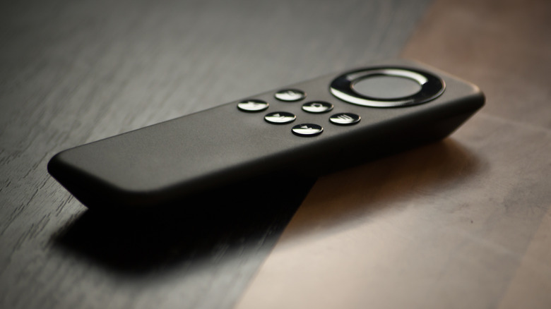 A close-up of an Amazon Fire TV remote control lying on a table.
