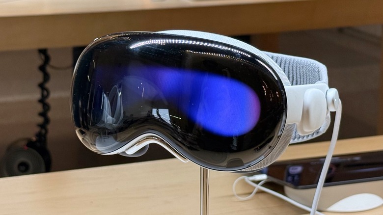 An Apple Vision Pro headset on display in a brightly lit retail environment.