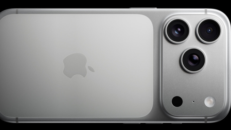 Detailed view of the triple-lens camera system on a pro-model iPhone.