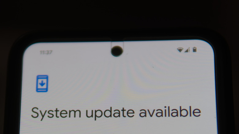 A Google Pixel smartphone displaying a system update notification on its screen.