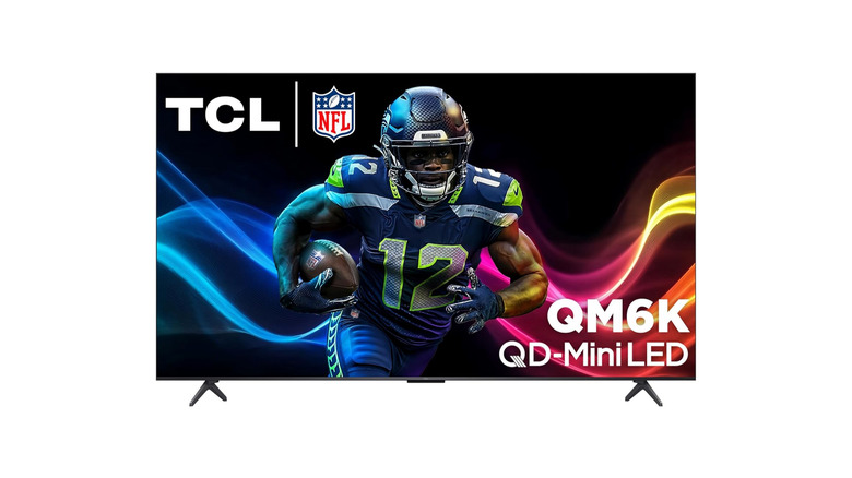 The TCL QM6K 55-inch TV showing a high-contrast image of a football player in action.