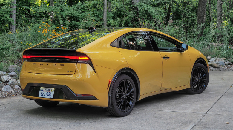 Rear 3/4 view of the 2025 Toyota Prius highlighting its sloping roofline.
