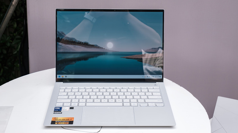 The ASUS Zenbook S 14 with a Ceraluminum finish resting on a round table.