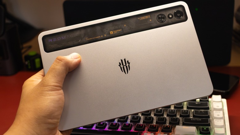 The author holding the Redmagic Astra with one hand to demonstrate its lightweight and ergonomic design.