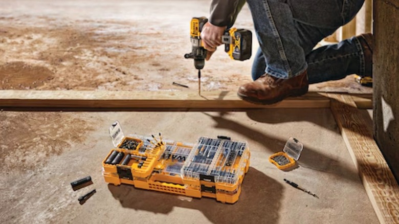 DeWalt FlexTorq impact ready bit sets displayed next to a worker using an impact driver.