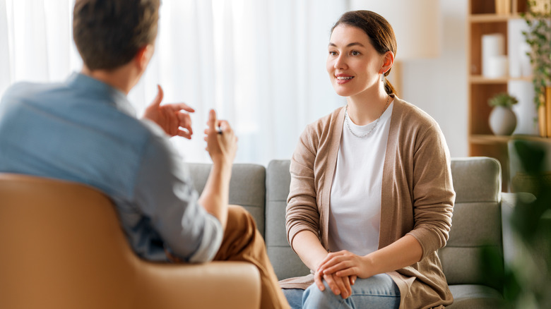 A woman talking to a therapist in a private office setting.