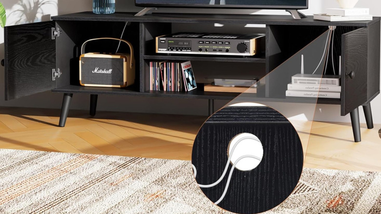 Sweetcrispy Entertainment Center with a TV on top and various AV components in the storage shelves.