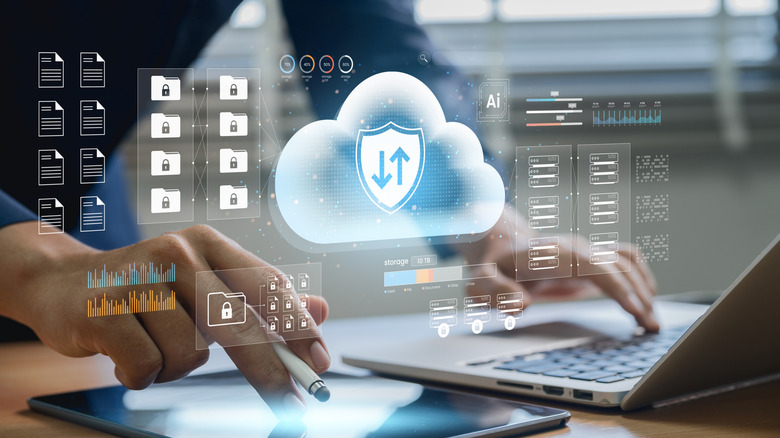 Person using a laptop and a tablet with cloud service imagery overlaid on top.