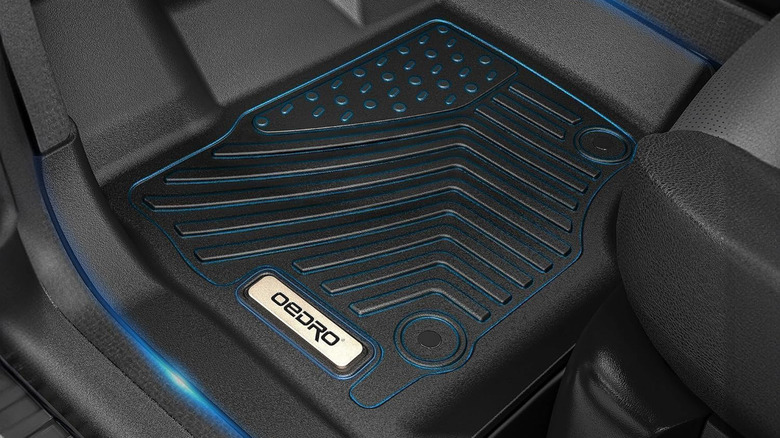 An Oedro floor mat installed in the front of a driver's seat.