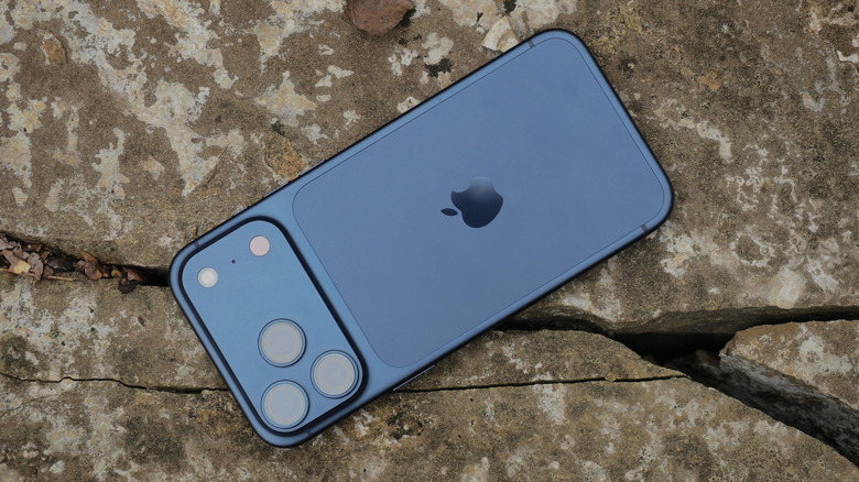 Close up of the iPhone 17 Pro rear panel resting on natural rock surfaces.
