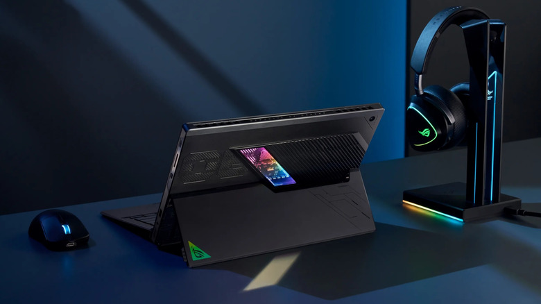 The ASUS ROG Flow Z13 standing on a desk with a gaming mouse and keyboard nearby.