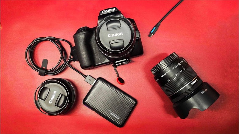 A camera connected to a portable power bank via a USB cable.