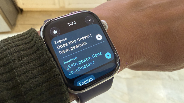 The Apple Watch screen showing a live translation of a phrase from English to Spanish.