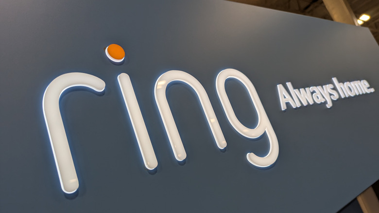 The Ring logo glowing on a textured grey surface.